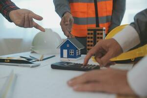 Construction and structure concept of Engineer or architect meeting for project working with partner and engineering tools on model building and blueprint in working site, contract for both companies. photo