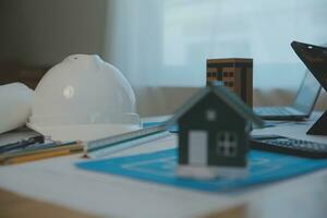 Construction and structure concept of Engineer or architect meeting for project working with partner and engineering tools on model building and blueprint in working site, contract for both companies. photo