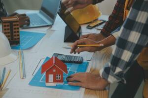 Construction and structure concept of Engineer or architect meeting for project working with partner and engineering tools on model building and blueprint in working site, contract for both companies. photo