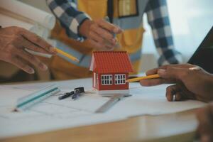 Construction and structure concept of Engineer or architect meeting for project working with partner and engineering tools on model building and blueprint in working site, contract for both companies. photo