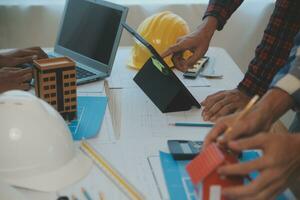 Construction and structure concept of Engineer or architect meeting for project working with partner and engineering tools on model building and blueprint in working site, contract for both companies. photo