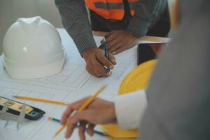 Construction and structure concept of Engineer or architect meeting for project working with partner and engineering tools on model building and blueprint in working site, contract for both companies. photo