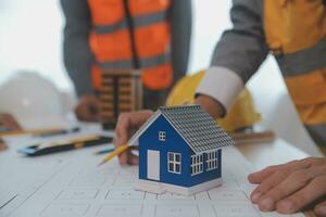 Construction and structure concept of Engineer or architect meeting for project working with partner and engineering tools on model building and blueprint in working site, contract for both companies. photo