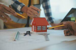 Construction and structure concept of Engineer or architect meeting for project working with partner and engineering tools on model building and blueprint in working site, contract for both companies. photo