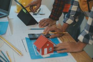 Construction and structure concept of Engineer or architect meeting for project working with partner and engineering tools on model building and blueprint in working site, contract for both companies. photo