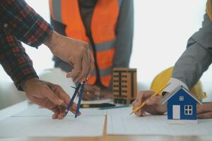 Construction and structure concept of Engineer or architect meeting for project working with partner and engineering tools on model building and blueprint in working site, contract for both companies. photo