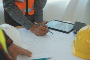 Construction and structure concept of Engineer or architect meeting for project working with partner and engineering tools on model building and blueprint in working site, contract for both companies. photo