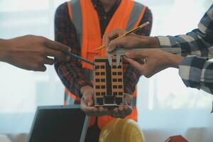 Construction and structure concept of Engineer or architect meeting for project working with partner and engineering tools on model building and blueprint in working site, contract for both companies. photo