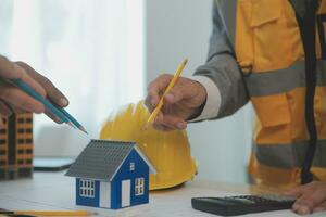 Construction and structure concept of Engineer or architect meeting for project working with partner and engineering tools on model building and blueprint in working site, contract for both companies. photo