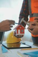 Construction and structure concept of Engineer or architect meeting for project working with partner and engineering tools on model building and blueprint in working site, contract for both companies. photo