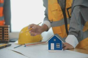 Construction and structure concept of Engineer or architect meeting for project working with partner and engineering tools on model building and blueprint in working site, contract for both companies. photo