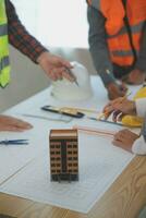 Construction and structure concept of Engineer or architect meeting for project working with partner and engineering tools on model building and blueprint in working site, contract for both companies. photo