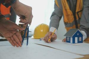 Construction and structure concept of Engineer or architect meeting for project working with partner and engineering tools on model building and blueprint in working site, contract for both companies. photo