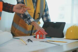 Construction and structure concept of Engineer or architect meeting for project working with partner and engineering tools on model building and blueprint in working site, contract for both companies. photo