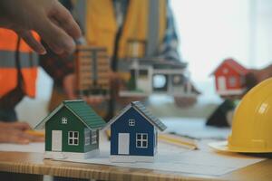 Construction and structure concept of Engineer or architect meeting for project working with partner and engineering tools on model building and blueprint in working site, contract for both companies. photo