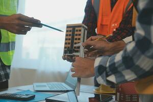 Construction and structure concept of Engineer or architect meeting for project working with partner and engineering tools on model building and blueprint in working site, contract for both companies. photo