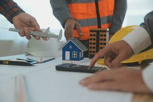 Construction and structure concept of Engineer or architect meeting for project working with partner and engineering tools on model building and blueprint in working site, contract for both companies. photo
