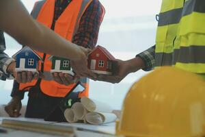 Construction and structure concept of Engineer or architect meeting for project working with partner and engineering tools on model building and blueprint in working site, contract for both companies. photo