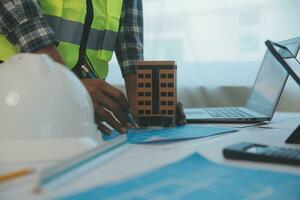 Construction and structure concept of Engineer or architect meeting for project working with partner and engineering tools on model building and blueprint in working site, contract for both companies. photo