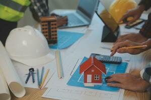 Construction and structure concept of Engineer or architect meeting for project working with partner and engineering tools on model building and blueprint in working site, contract for both companies. photo