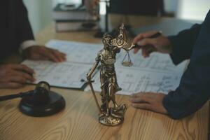 Consultation and conference of Male lawyers and professional businesswoman working and discussion having at law firm in office. Concepts of law, Judge gavel with scales of justice. photo