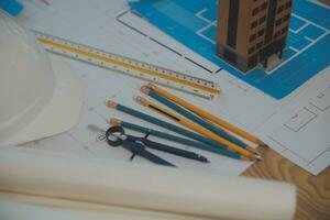 Construction and structure concept of Engineer or architect meeting for project working with partner and engineering tools on model building and blueprint in working site, contract for both companies. photo