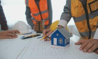 Construction and structure concept of Engineer or architect meeting for project working with partner and engineering tools on model building and blueprint in working site, contract for both companies. photo