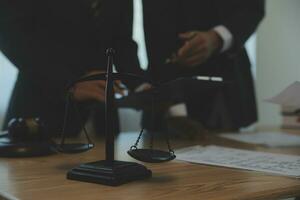 Consultation and conference of Male lawyers and professional businesswoman working and discussion having at law firm in office. Concepts of law, Judge gavel with scales of justice. photo