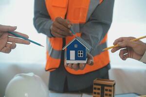 Construction and structure concept of Engineer or architect meeting for project working with partner and engineering tools on model building and blueprint in working site, contract for both companies. photo