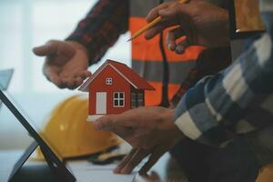Construction and structure concept of Engineer or architect meeting for project working with partner and engineering tools on model building and blueprint in working site, contract for both companies. photo