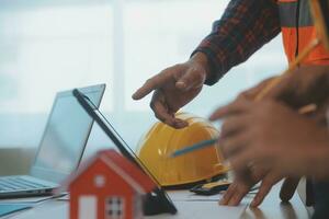 Construction and structure concept of Engineer or architect meeting for project working with partner and engineering tools on model building and blueprint in working site, contract for both companies. photo