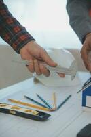 Construction and structure concept of Engineer or architect meeting for project working with partner and engineering tools on model building and blueprint in working site, contract for both companies. photo