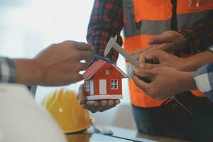 Construction and structure concept of Engineer or architect meeting for project working with partner and engineering tools on model building and blueprint in working site, contract for both companies. photo