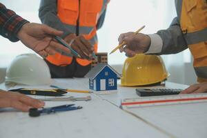 Construction and structure concept of Engineer or architect meeting for project working with partner and engineering tools on model building and blueprint in working site, contract for both companies. photo