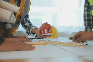 Construction and structure concept of Engineer or architect meeting for project working with partner and engineering tools on model building and blueprint in working site, contract for both companies. photo