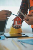 Construction and structure concept of Engineer or architect meeting for project working with partner and engineering tools on model building and blueprint in working site, contract for both companies. photo