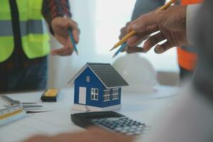 Construction and structure concept of Engineer or architect meeting for project working with partner and engineering tools on model building and blueprint in working site, contract for both companies. photo