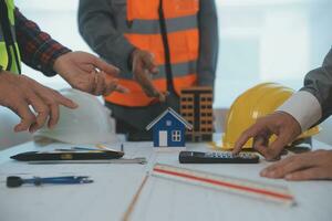 Construction and structure concept of Engineer or architect meeting for project working with partner and engineering tools on model building and blueprint in working site, contract for both companies. photo