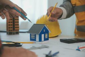 Construction and structure concept of Engineer or architect meeting for project working with partner and engineering tools on model building and blueprint in working site, contract for both companies. photo