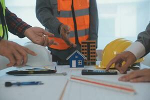 Construction and structure concept of Engineer or architect meeting for project working with partner and engineering tools on model building and blueprint in working site, contract for both companies. photo