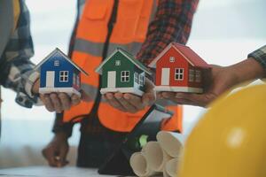 Construction and structure concept of Engineer or architect meeting for project working with partner and engineering tools on model building and blueprint in working site, contract for both companies. photo