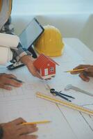 Construction and structure concept of Engineer or architect meeting for project working with partner and engineering tools on model building and blueprint in working site, contract for both companies. photo