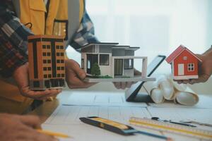 Construction and structure concept of Engineer or architect meeting for project working with partner and engineering tools on model building and blueprint in working site, contract for both companies. photo