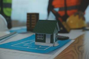 Construction and structure concept of Engineer or architect meeting for project working with partner and engineering tools on model building and blueprint in working site, contract for both companies. photo