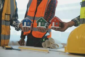 Construction and structure concept of Engineer or architect meeting for project working with partner and engineering tools on model building and blueprint in working site, contract for both companies. photo