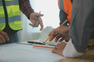 Construction and structure concept of Engineer or architect meeting for project working with partner and engineering tools on model building and blueprint in working site, contract for both companies. photo