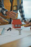 Construction and structure concept of Engineer or architect meeting for project working with partner and engineering tools on model building and blueprint in working site, contract for both companies. photo
