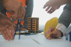 Construction and structure concept of Engineer or architect meeting for project working with partner and engineering tools on model building and blueprint in working site, contract for both companies. photo