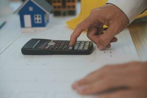 Construction and structure concept of Engineer or architect meeting for project working with partner and engineering tools on model building and blueprint in working site, contract for both companies. photo