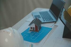 Construction and structure concept of Engineer or architect meeting for project working with partner and engineering tools on model building and blueprint in working site, contract for both companies. photo